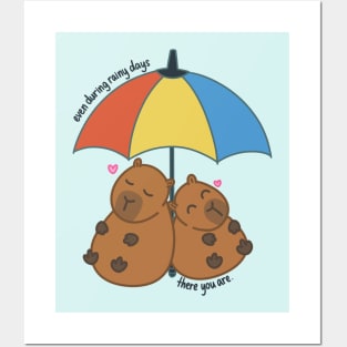 Capybara Couple in Love Under Rainbow Umbrella During Rainy Days Posters and Art